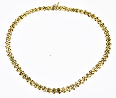 Lot 1315 - A flat link yellow metal necklace stamped '14k'...
