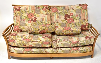 Lot 6 - ERCOL; a mid-coloured beech three-seater...