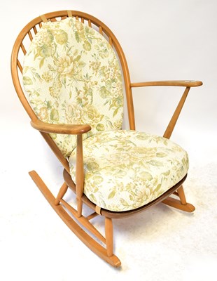 Lot 8 - ERCOL; a light elm stick back rocking chair...