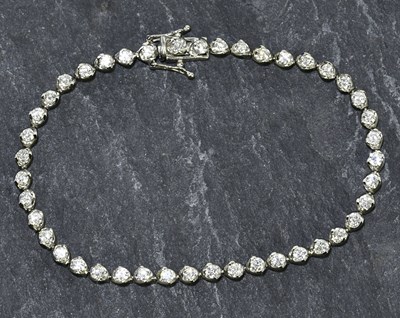 Lot 1243 - An 18ct white gold diamond set tennis bracelet...