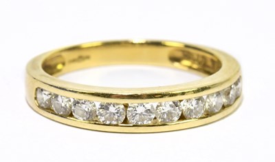 Lot 1024 - An 18ct yellow gold and diamond half eternity...