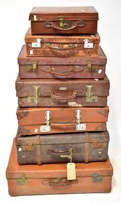 Lot 276 - Seven leather suitcases of varying sizes, one...