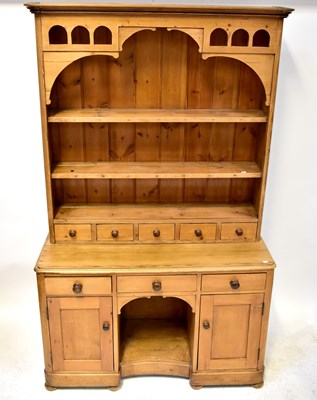 Lot 59 - A pine dresser with an enclosed plate rack of...