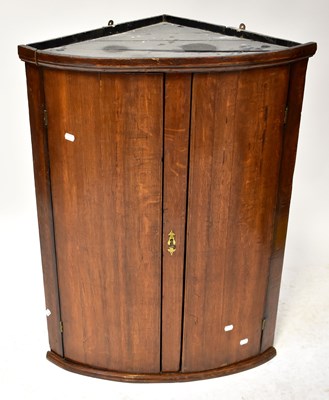 Lot 34 - A 19th century oak bow-fronted corner cupboard,...