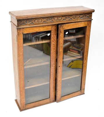 Lot 12 - A mid-20th century oak display cabinet, with...