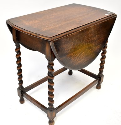 Lot 18 - A 1930s oak drop-leaf gateleg table, on barley...
