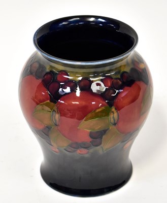 Lot 152 - MOORCROFT; a 'Pomegranate' vase of green blue...