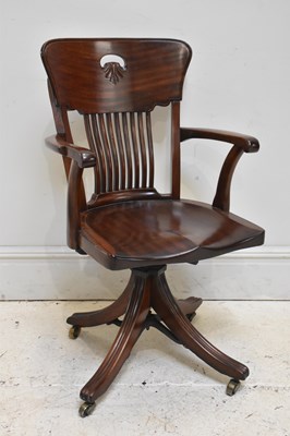 Lot 158 - A reproduction carved mahogany swivel office...