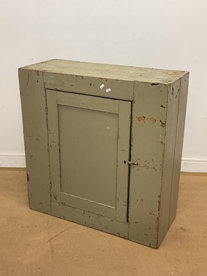 Lot 772 - A painted pine cupboard with a single door,...