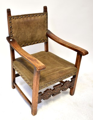 Lot 65 - A leather studded carved open arm chair with...