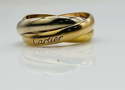 Lot 576 - CARTIER; an 18ct three tone gold trilogy ring,...