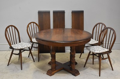 Lot 147 - A reproduction oak extending dining table,...