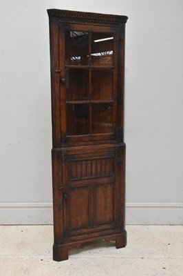 Lot 162 - A reproduction oak freestanding corner...