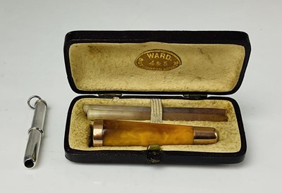 Lot 673 - A leather cased gold mounted amber cheroot...