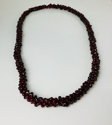 Lot 676 - A garnet bead necklace, length 60cm.