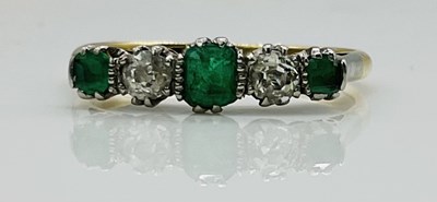Lot 602 - An 18ct yellow gold emerald and diamond five...
