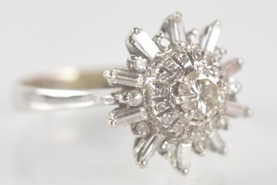 Lot 1299 - A white metal diamond cluster ring, the...