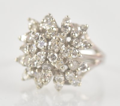 Lot 1296 - A white metal floral diamond cluster ring, set...