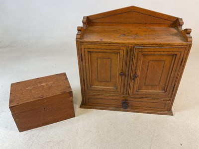 Lot 828 - A pine smoking cabinet, with two doors over...