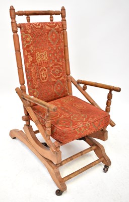Lot 64 - An American rocking chair in beech,...