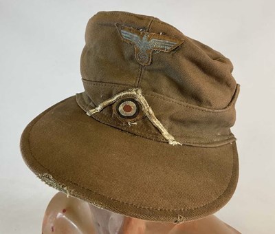 Lot 257 - A WWII German desert forage cap, with insignia...