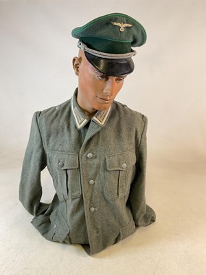 Lot 270 - A WWII German Tunic and officer's visor cap,...