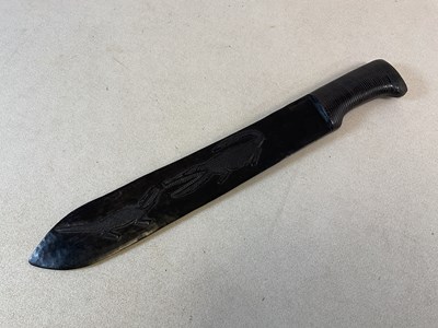 Lot 350 - An African carved hardwood machete, decorated...