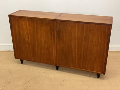 Lot 796 - A mid 20th century teak cupboard on ebonised...