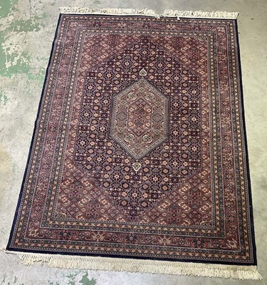 Lot 720 - A machine and hand knotted Royal Keshan rug,...