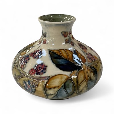 Lot 553 - MOORCROFT; a squat vase, decorated in the...