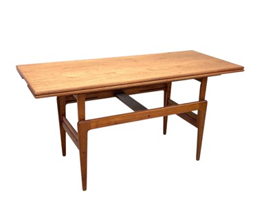 Lot 23 - A mid century teak draw-leaf adjustable dining...