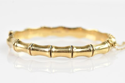 Lot 1159 - A 9ct yellow gold hinged snap bangle, internal...