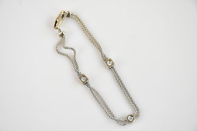 Lot 1132 - A white metal textured diamond set bracelet,...