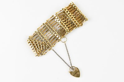 Lot 1160 - A yellow metal gate link bracelet, with 9ct...