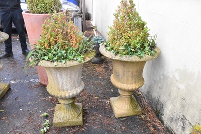Lot 330 - A pair of reconstituted stone garden urns on...
