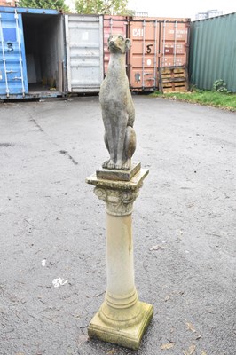 Lot 336 - A reconstituted stone figure of a seated...