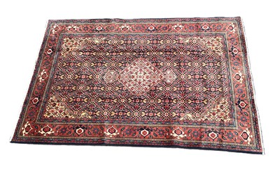 Lot 390 - An orange ground hand knotted woollen Persian...