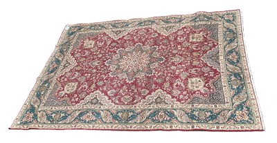 Lot 393 - A dark mauve ground Caucasian carpet, with...