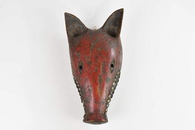 Lot 1193 - A Tanzanian Makonde Mawia red painted helmet...
