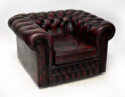 Lot 70 - CHESTERFIELD; an oxblood leather three-seat...