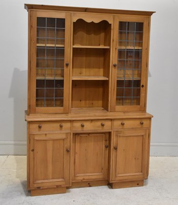 Lot 78 - An old pine kitchen cupboard with two leaded...