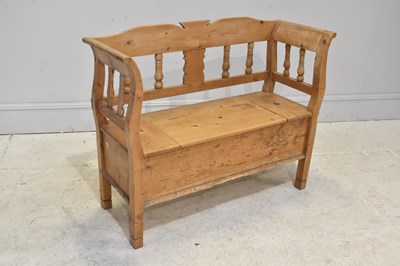 Lot 76 - A vintage pine settle, with open back and...