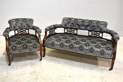 Lot 254 - A late Victorian carved walnut framed two...