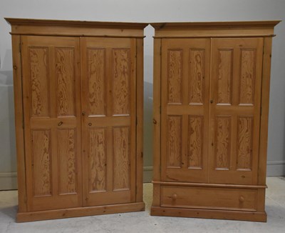 Lot 64 - Two pine twin door wardrobes, on plinth bases,...
