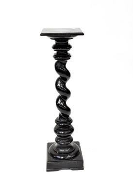 Lot 68 - A large ebonised torchère stand raised on...