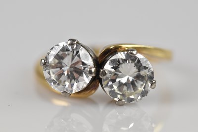 Lot 2239 - A yellow metal diamond two stone crossover...
