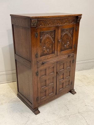 Lot 171 - A reproduction carved oak drinks/cocktail...