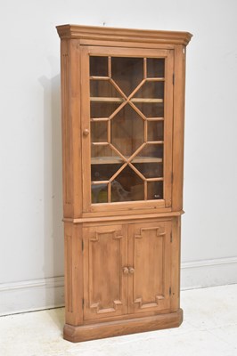 Lot 99 - An old pine freestanding corner cupboard, with...