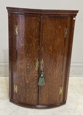 Lot 318 - A Georgian crossbanded oak hanging bowfront...