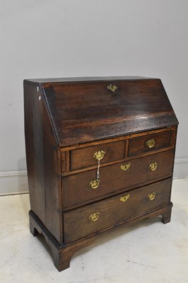 Lot 100 - An 18th century oak bureau, the fall front...